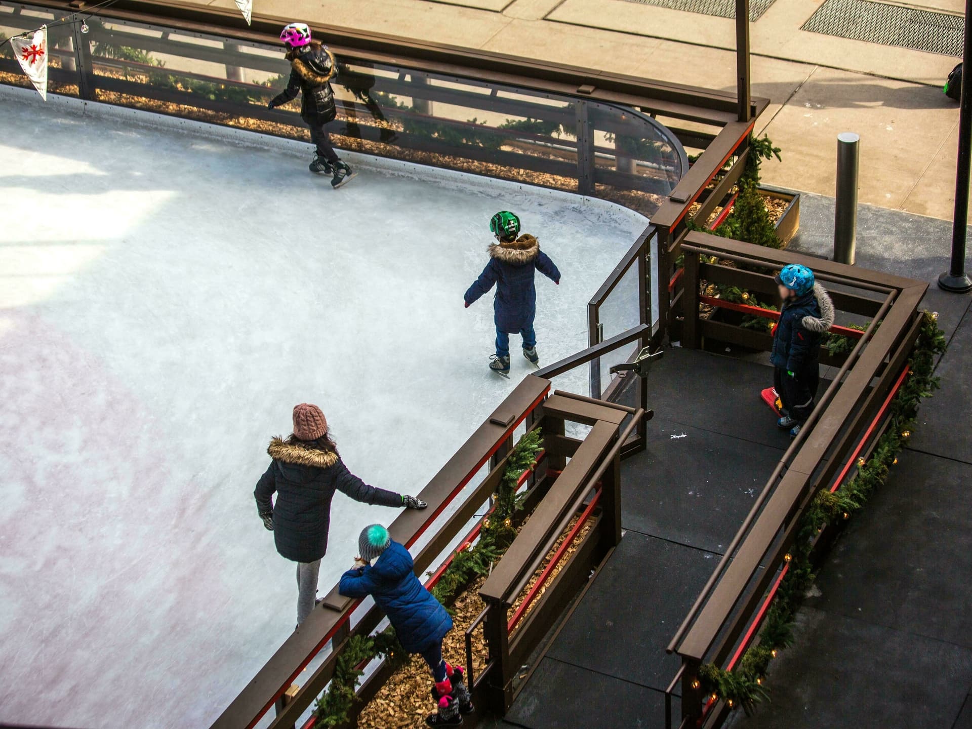Outdoor ice rink with children skating on it