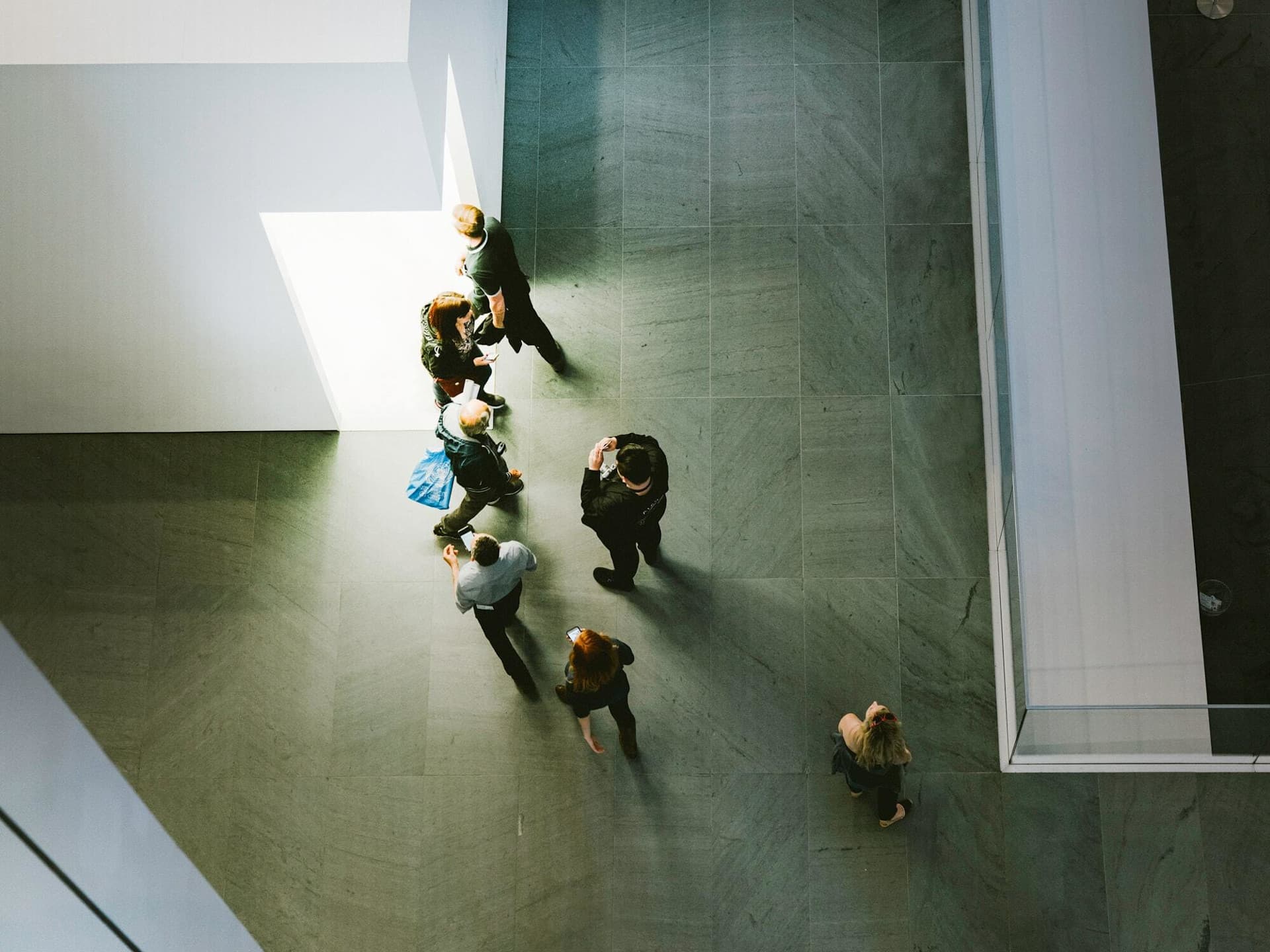 Top down view of people in grey space